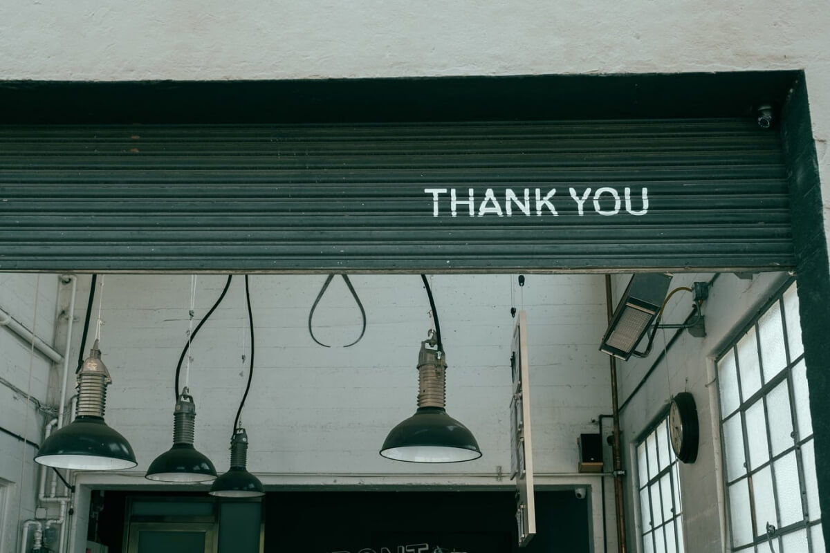 garage door open with Thank You in stencil on it