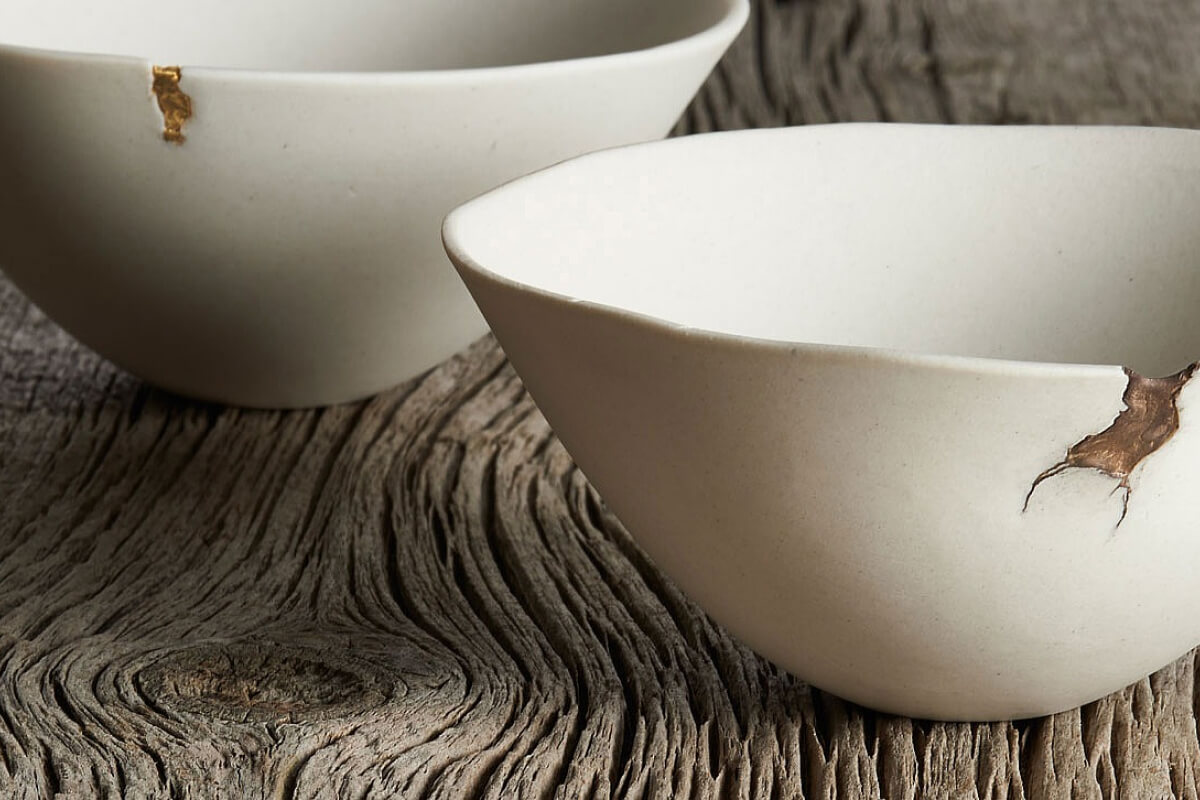 bowls with gold sealing the cracks in the bowl representing wabi sabi