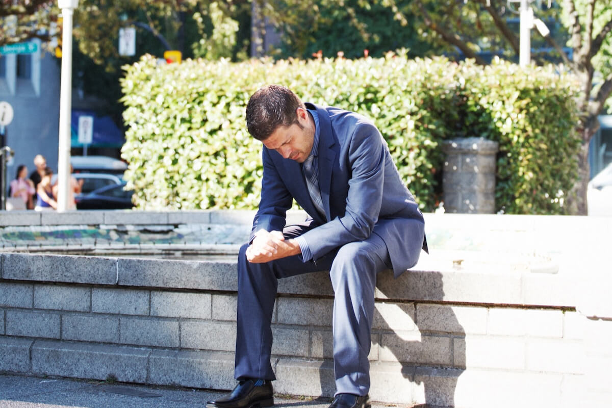 upset man sitting outside