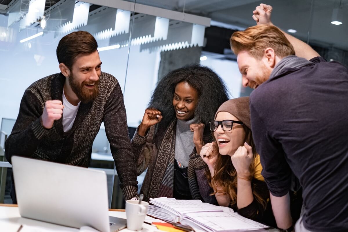 cheerful office coworkers gathered having fun while celebrating their performance