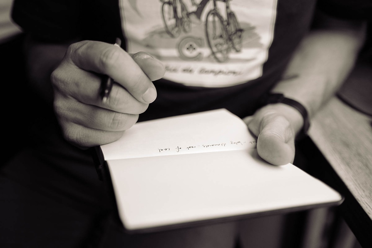 black and white image of man journaling