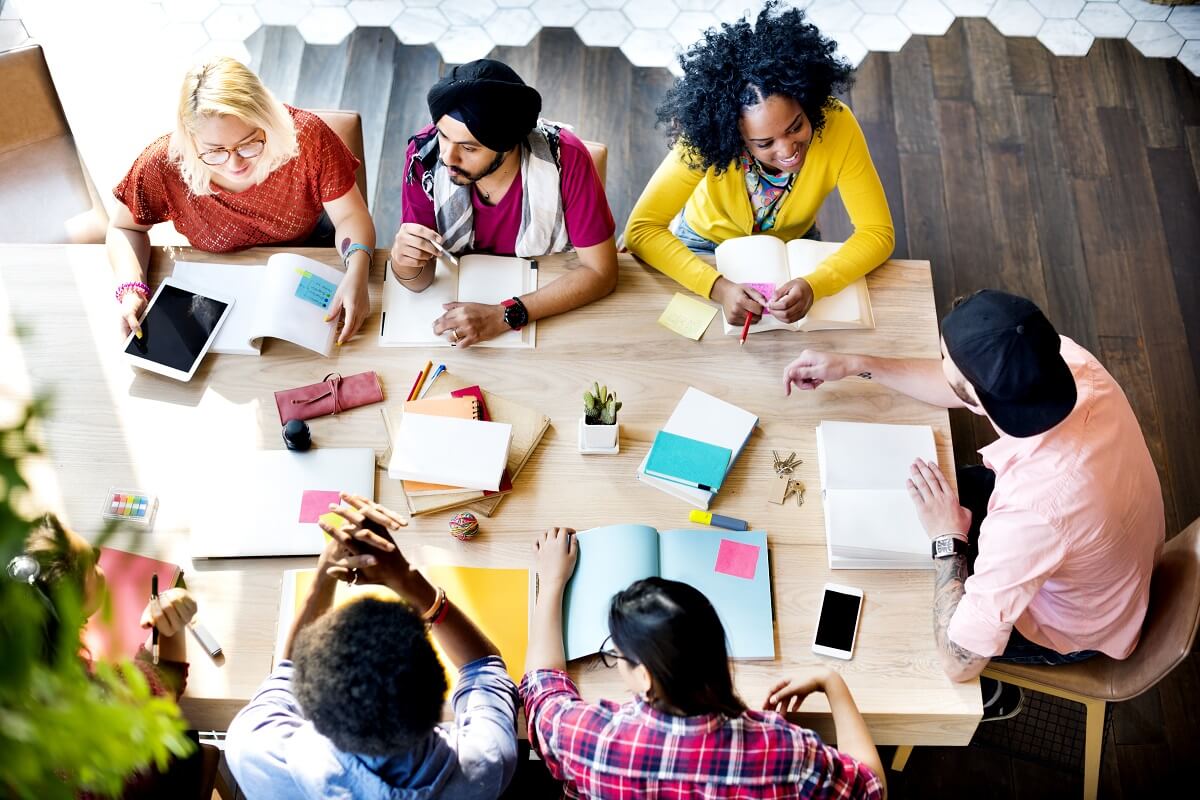 Diverse group of employees demonstrating EI by working together in a conference room