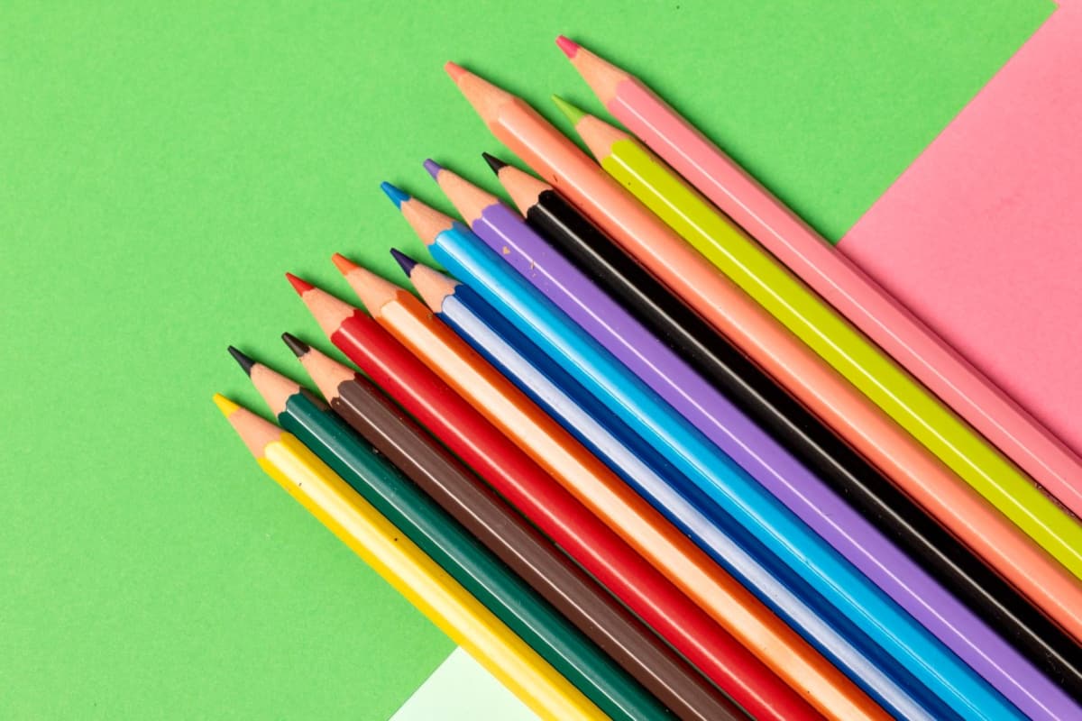 Colored pencils on green and pink construction paper
