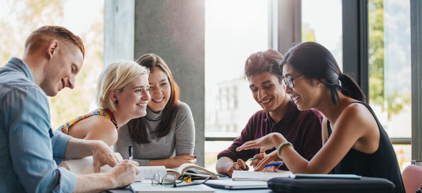 Group of young adults working and laughing together