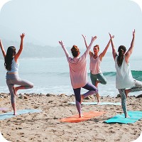 Woman doing yoga on the beach