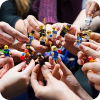 Group holding Lego toys in a circle