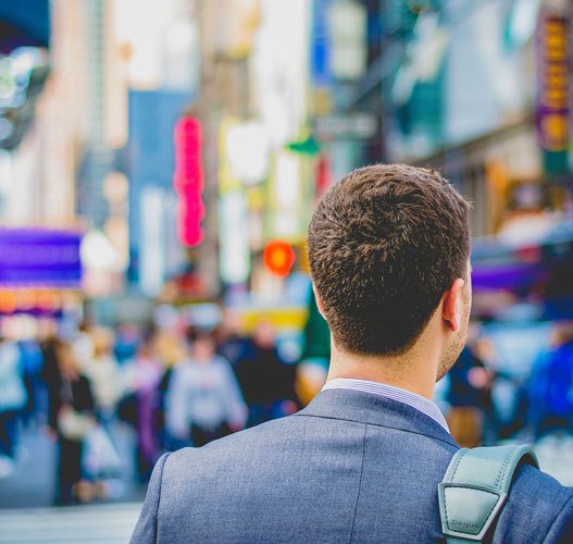 man walking in a busy city