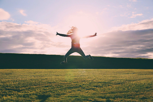 Woman jumping up in a field