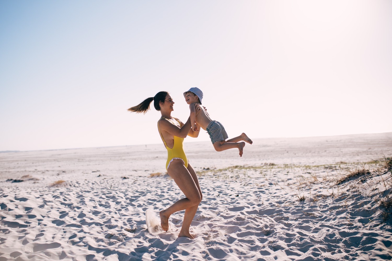 Mum and son playing at the beach