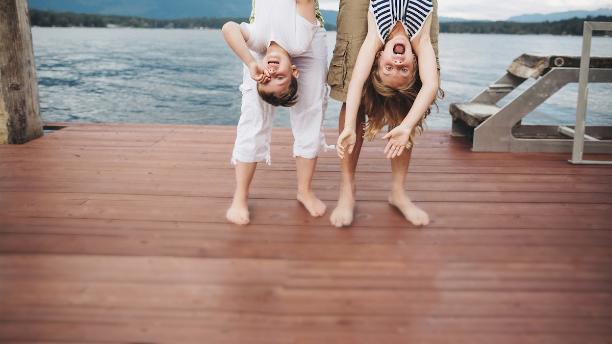 Parents playing with kids on dock decking