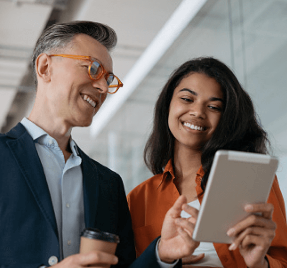 Man and woman smiling at tablet