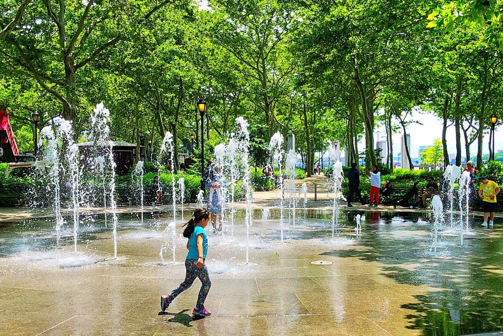 Children playing in water fountain area