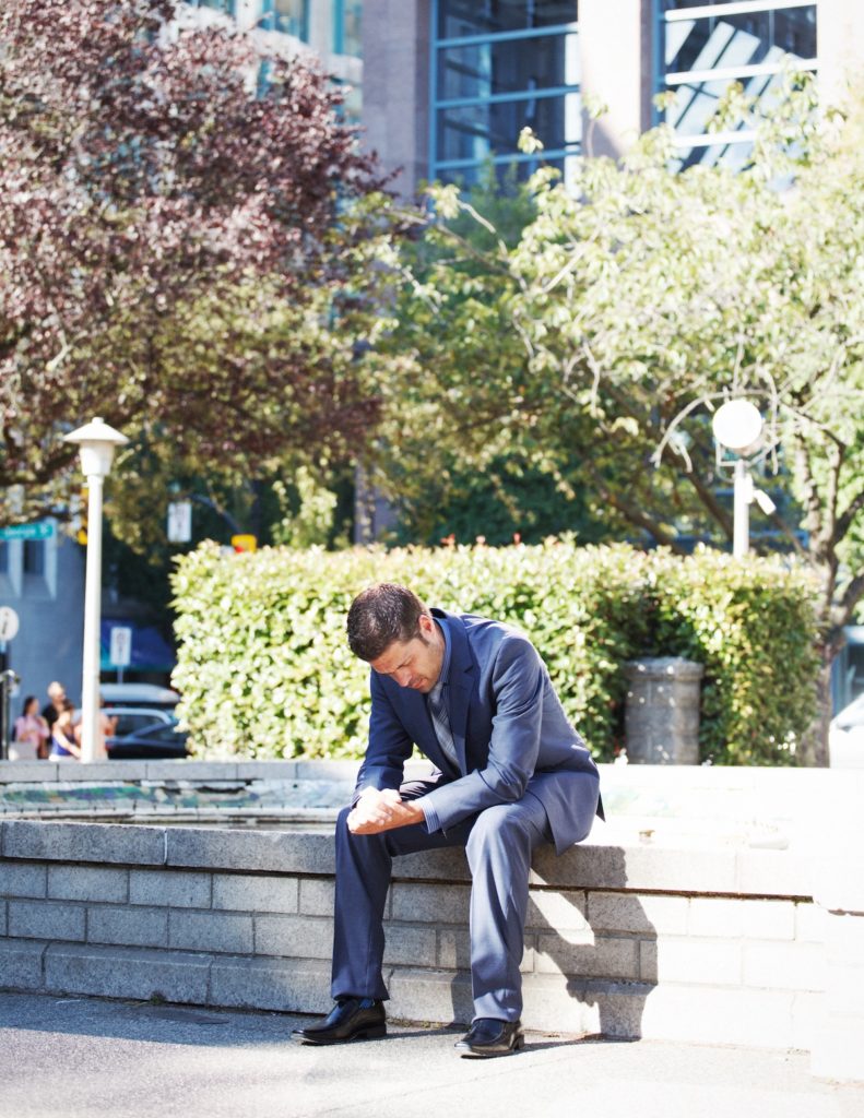 upset man sitting outside
