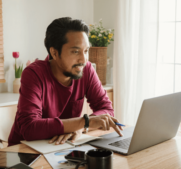 Man at desk using a laptop