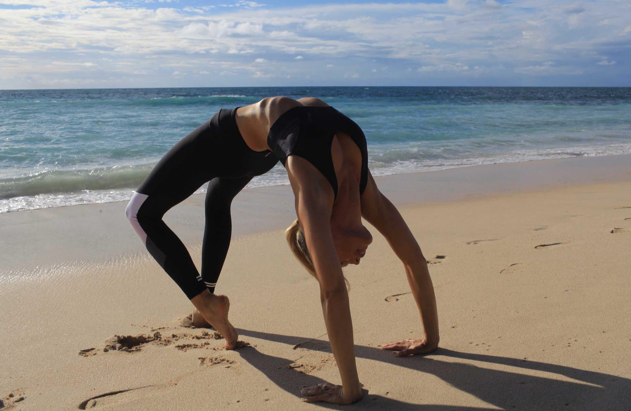 Woman doing yoga on the beach