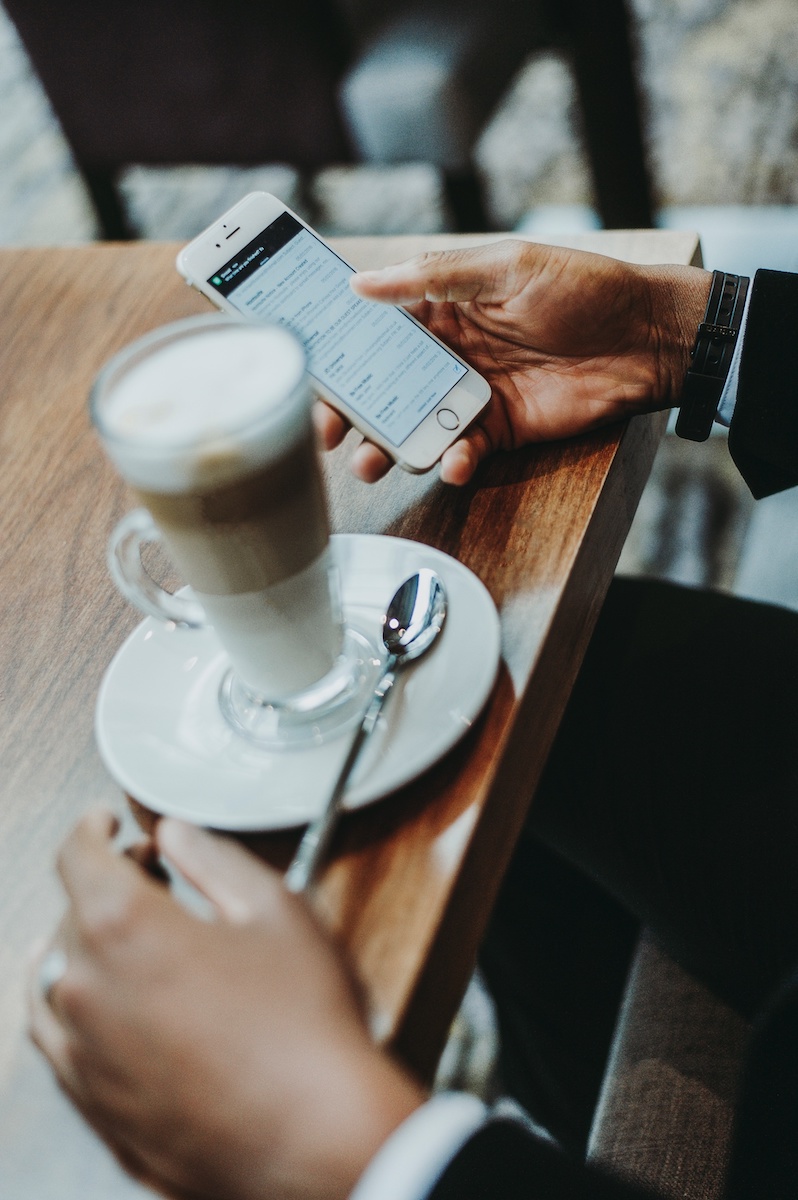 Man on his phone at a coffee shop