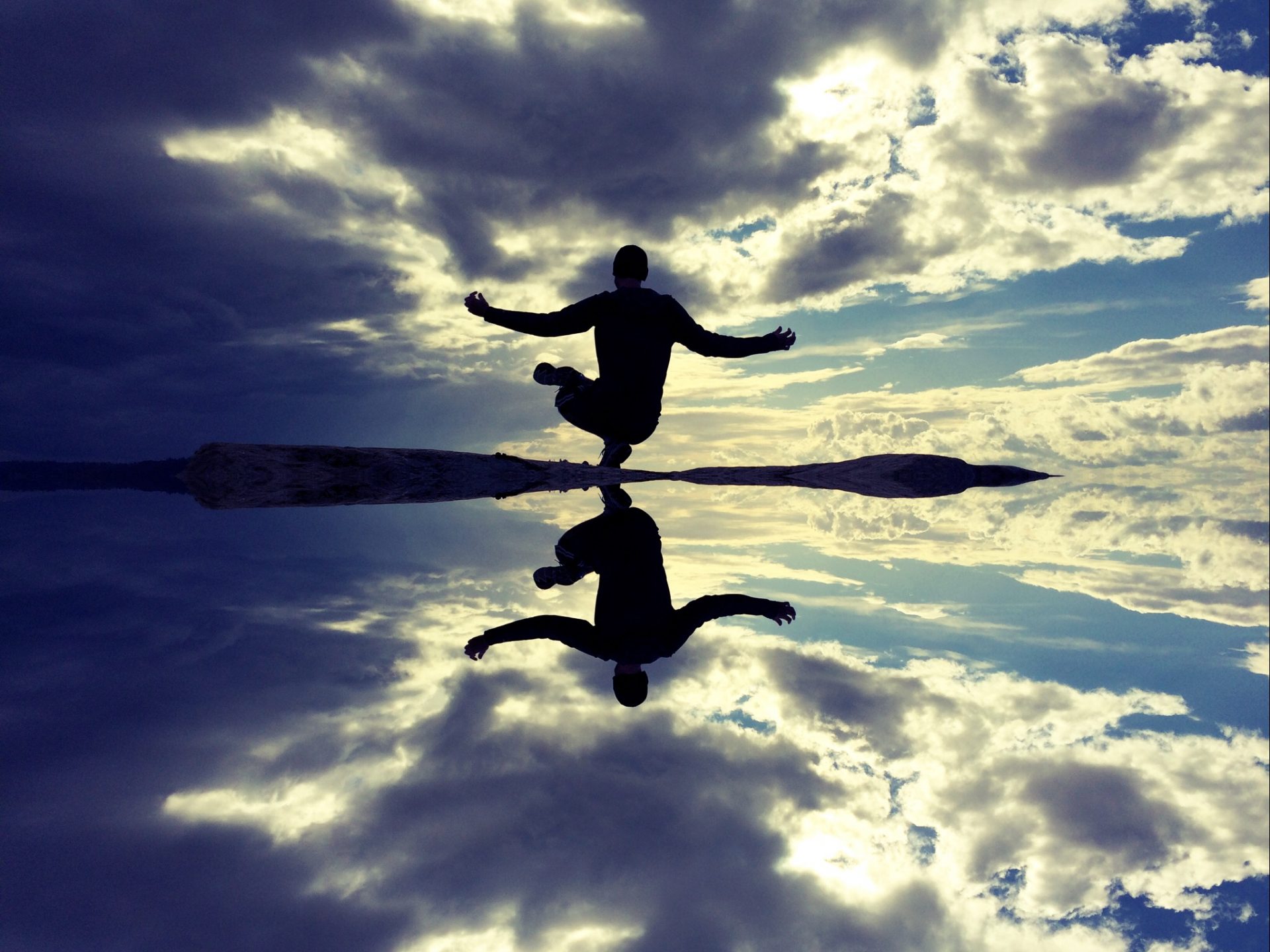 Man mediating by clear water