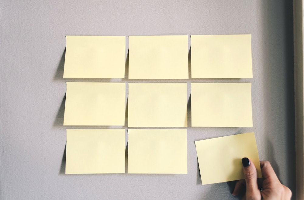 Woman putting post-its on the wall