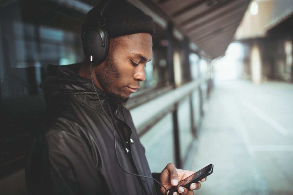 Man is listening to music with his smartphone