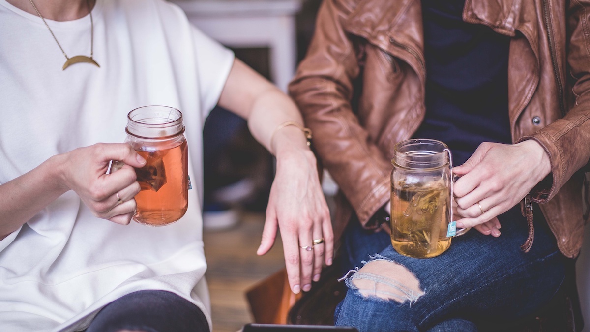 people drinking tea from a mason jar