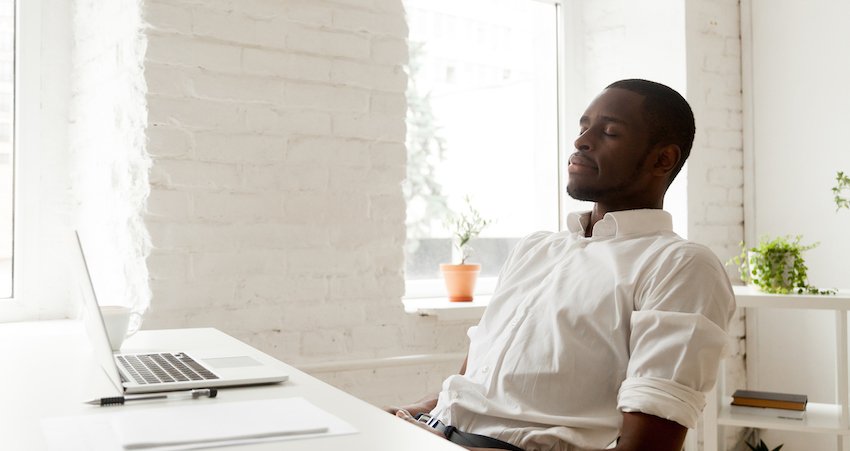 Man meditating at his desk