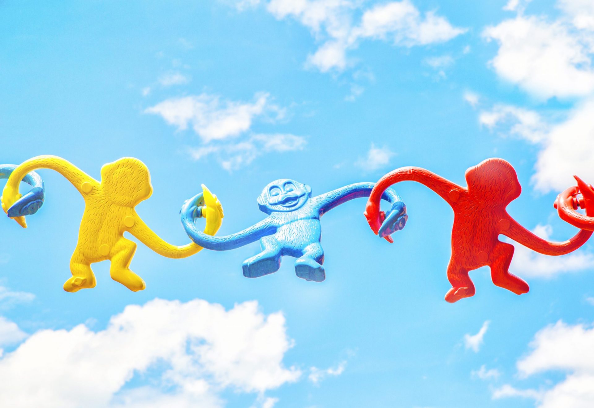 Toy monkeys with the sky in the background