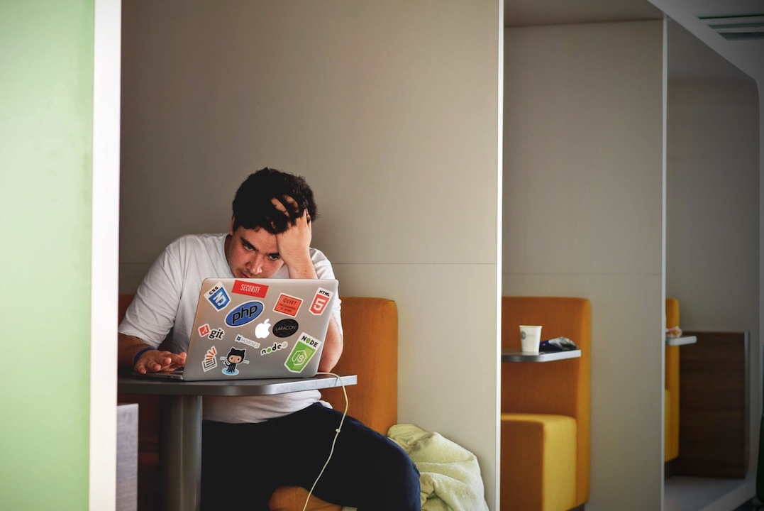 tired employee working on his laptop