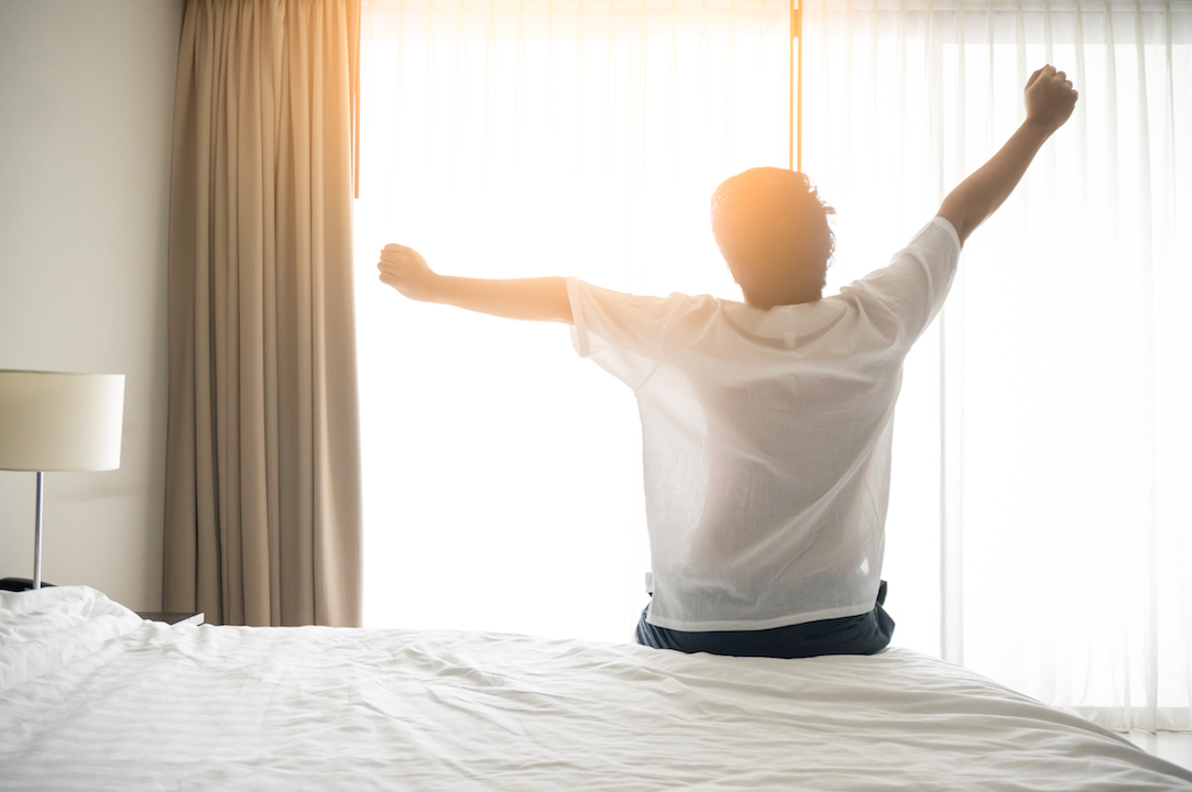 Man stretching on the bed