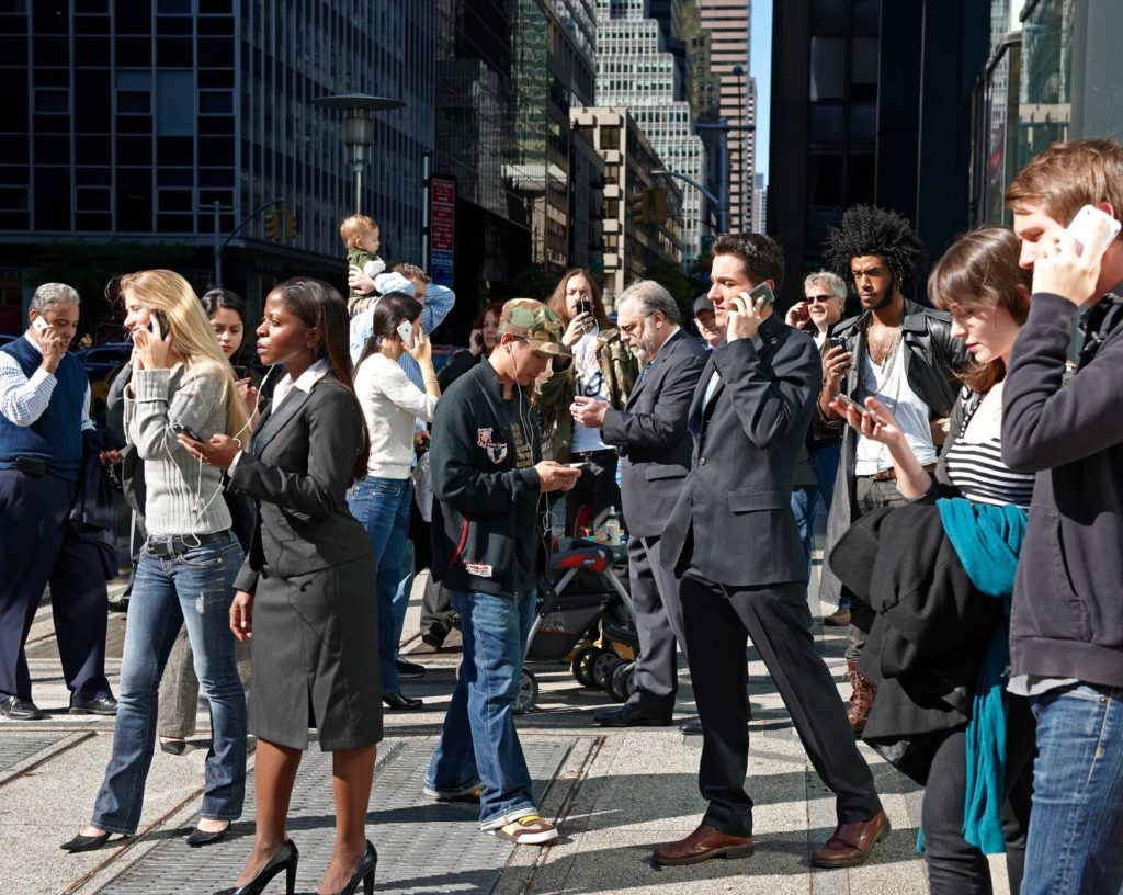Talking on the phone while walking on a busy street