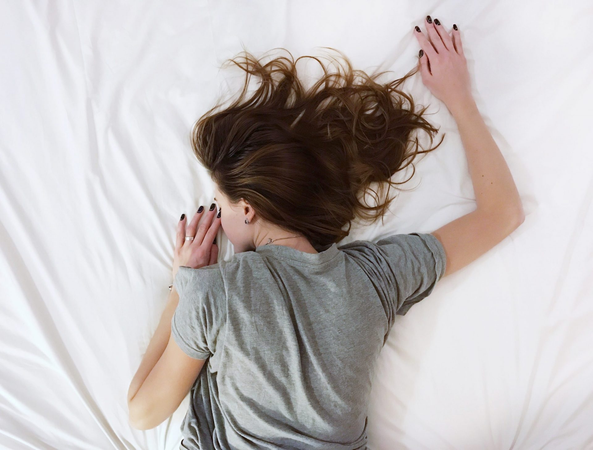 Woman laying on the bed tired