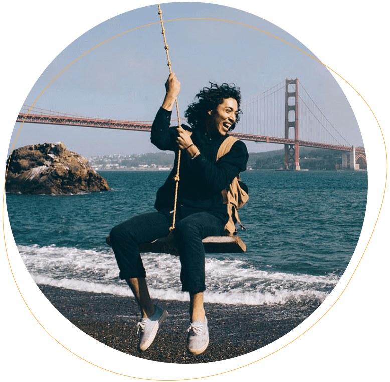 Woman using swing near Golden Gate Bridge river