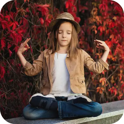 Young girl meditating outside