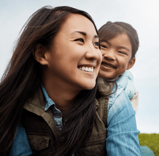 Asian mother and daughter in field