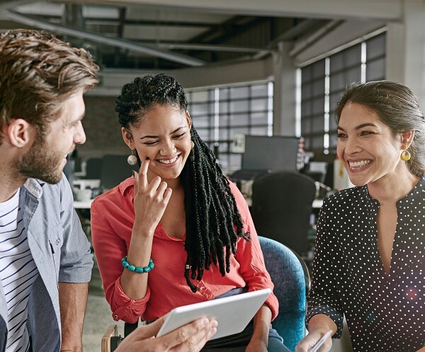 Man and two women have happy conversation at work