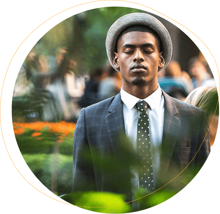 African American man with closed eyes thinking in a park