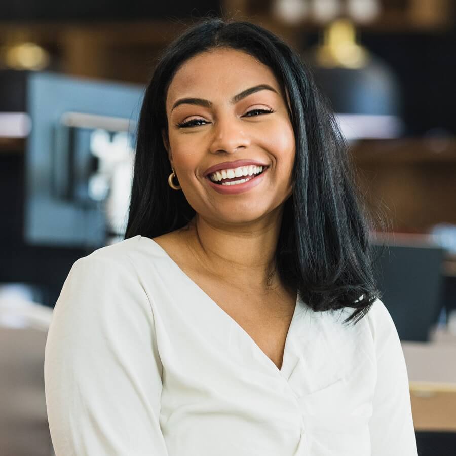 Female business owner poses for photo at work