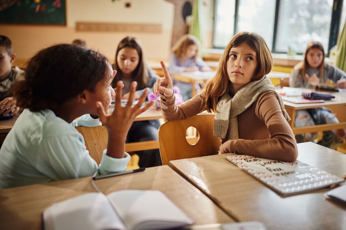 Elementary student ignoring her friend during an conflict in the classroom.