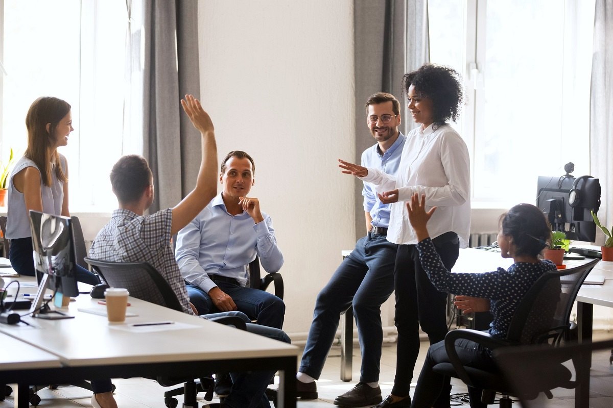 Neurodiverse business team in coworking space voting some colleagues agree raising hands