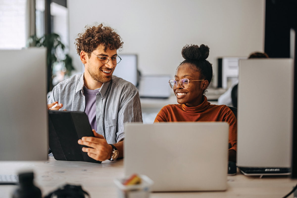 Two young colleagues, one with ADHD, working together in modern office