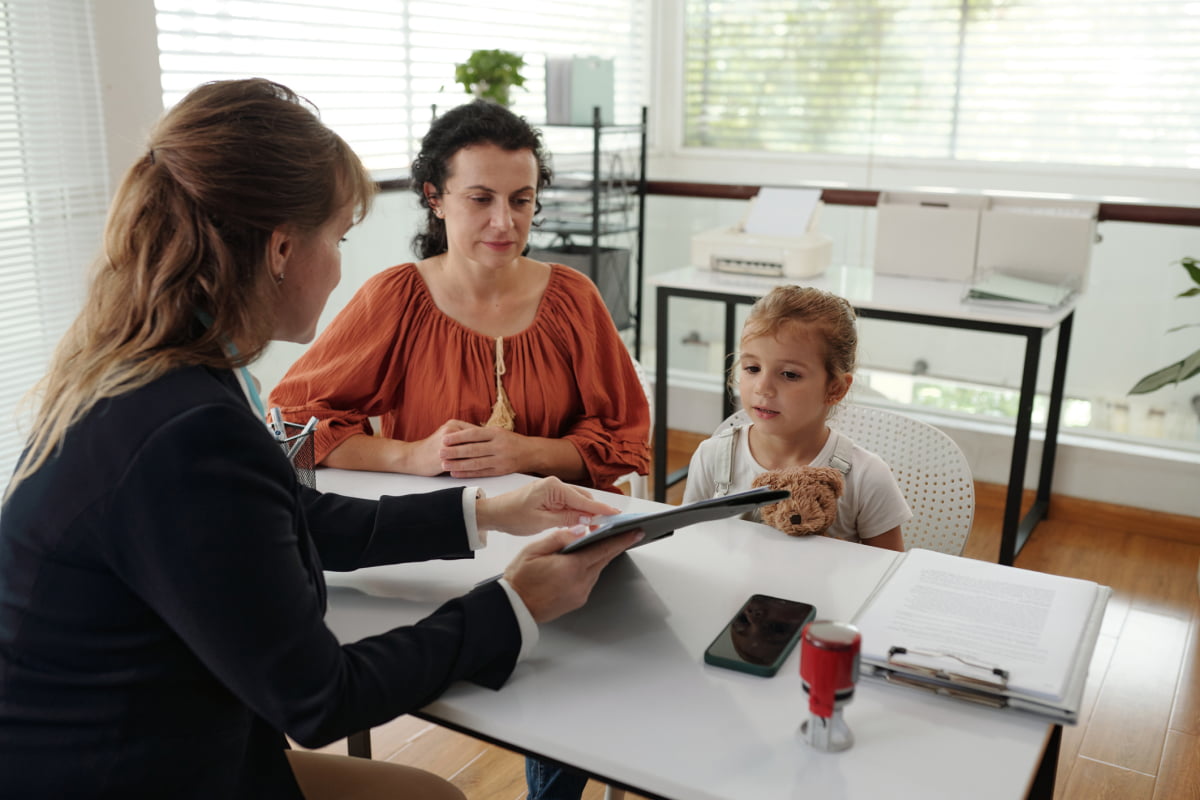 BCBA explaining diagnosis to little girl and her mother